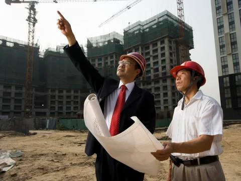 Architect on the job site with a worker. Stock Photos