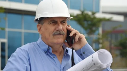 Architect on joib site talking on mobile phone Stock Footage 121381047