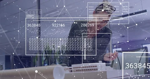 Architect leaning over model and activating 3D data overlays while using printed Stock Footage 309893224