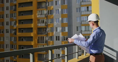 Architect looks around apartment complex and examines design Video stock 221781417