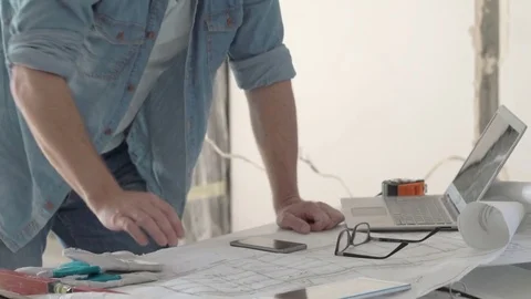 Architect looks irritated while working on the project in his new flat, steadyca Stock-Footage 76493251