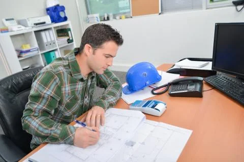 Architect making notes on house plans Stock Photos