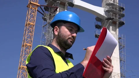 Architect man developing blueprints drawing papers construction site background Stock Footage 76310204