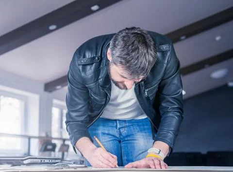 Architect man drawing construction project on desk Stock Photos