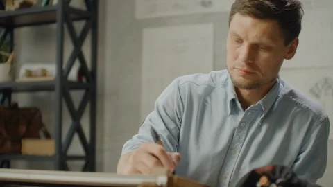 Architect man Standing working with blueprints sketching a construction project Video stock 121526360
