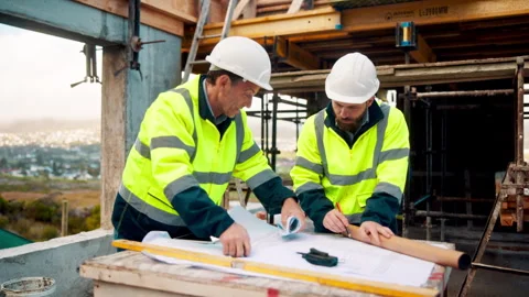 Architect, men and blueprint at construction site, discussion and development Stock Footage 336218946