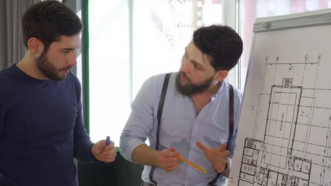 Architect moves his hand over the design of the building Stock-Footage 73911475