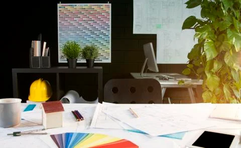 Architect office: tablet, projects and color swatches on desk Stock Photos