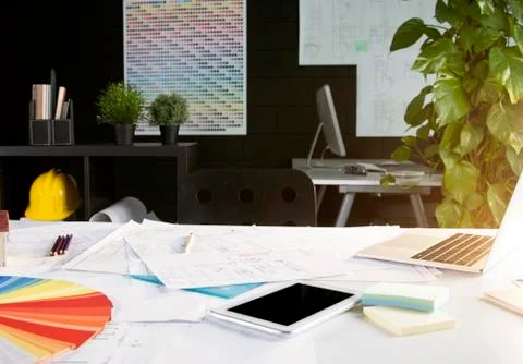 Architect office: tablet, projects and color swatches on desk Stock Photos