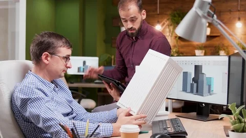 Architect in the office talking about the engineering for the new building Stock Footage 115071894