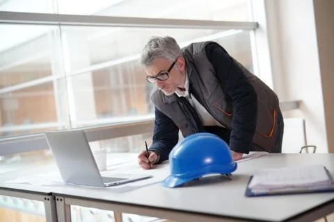 Architect in office working on building project Stock Photos