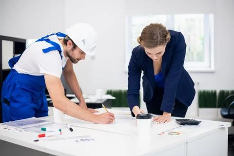 Architect or construction design concept. A young female engineer and a Stock Photos
