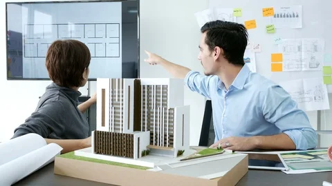 Architect or engineer is concentrating as he examines the new building project. Stock Footage 91272118