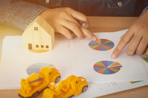 Architect or engineer points to circular graph. Stock Photos