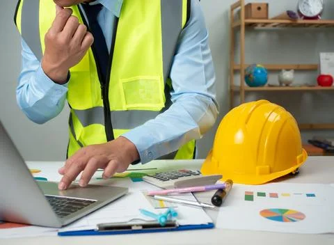 Architect or engineer using computer to work on desk, Cost calculation, Con.. Stock Photos