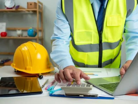 Architect or engineer using computer to work on desk, Cost calculation, Con.. Stock Photos