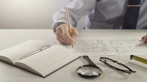 Architect or engineer using pencil working on blueprint, architectural concept Stock Footage 81216122