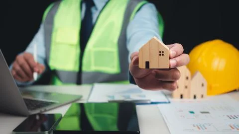 Architect or engineer using tablet to work on table, Construction planning,.. Stock Photos