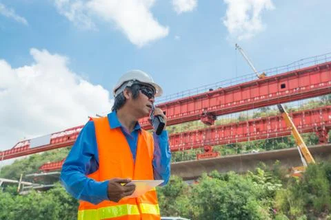 Architect or Engineer, wearing white Hardhat and safety vest, use Radio Commu Stock Photos
