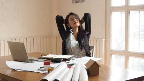 Architect or engineer woman stretch and relax from fatigue after work all day. Stock Footage 107874441