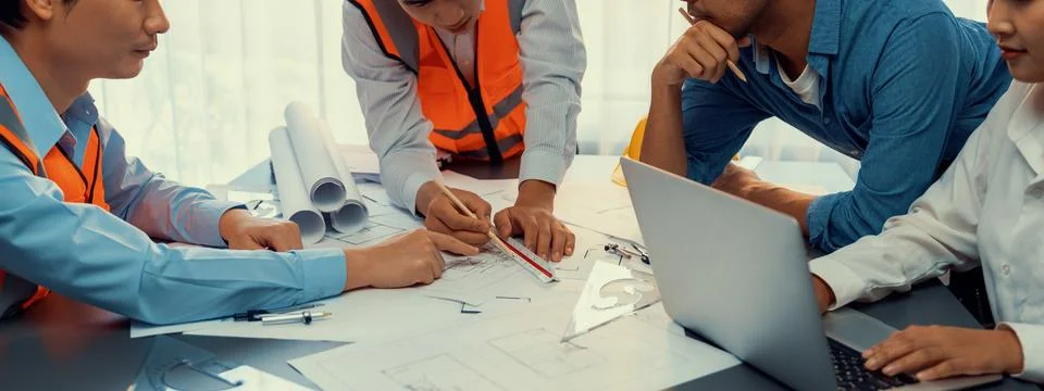Architect or engineer working on building blueprint in office. Insight Fotos de archivo