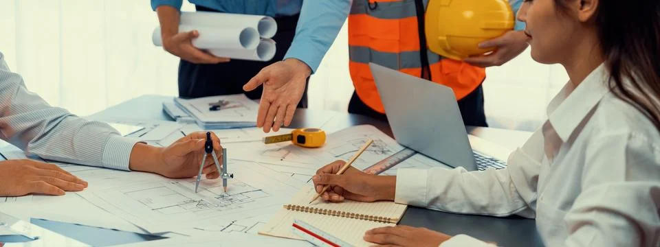 Architect or engineer working on building blueprint in office. Insight Fotos de archivo