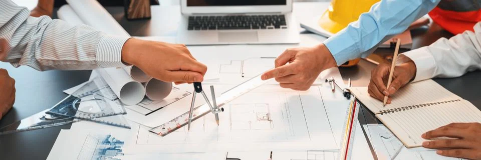 Architect or engineer working on building blueprint in office. Insight Stock Photos