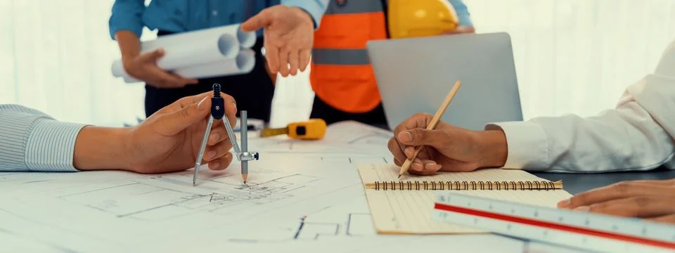 Architect or engineer working on building blueprint in office. Insight Fotos de archivo