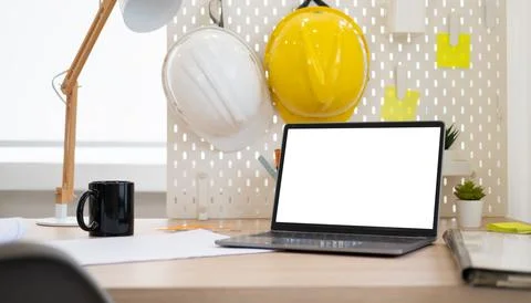 Architect or engineer working desk with laptop computer, yellow helmet, blu.. Stock Photos