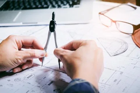 Architect or engineer working in office on blueprint. Architects workplace .. Stock Photos