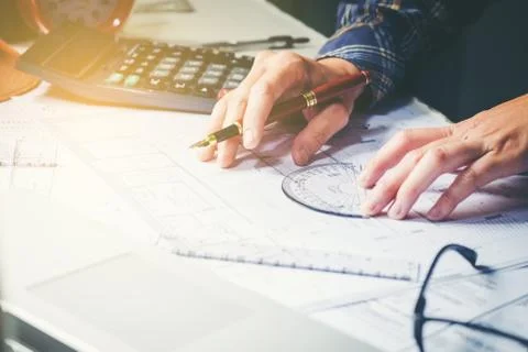 Architect or engineer working in office on blueprint. Architects workplace .. Stock Photos