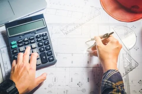 Architect or engineer working in office on blueprint. Architects workplace .. Stock Photos