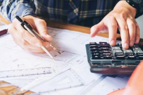 Architect or engineer working in office on blueprint. Architects workplace .. Stock Photos