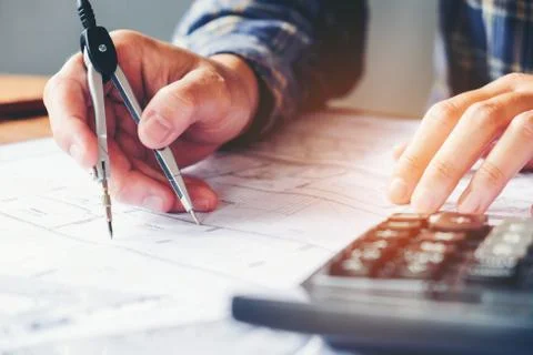 Architect or engineer working in office on blueprint. Architects workplace .. Stock Photos