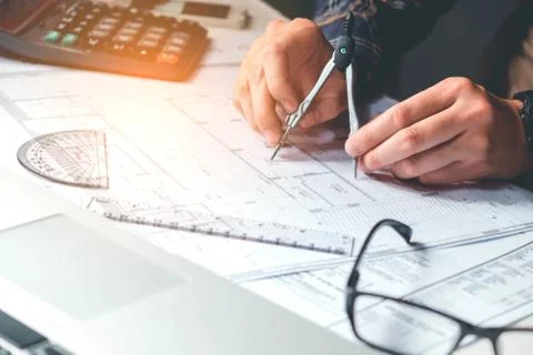 Architect or engineer working in office on blueprint. Architects workplace , Stock Photos