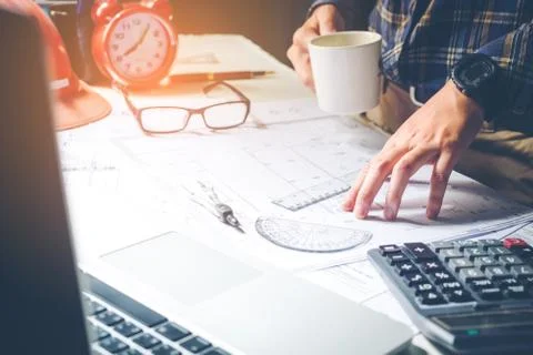 Architect or engineer working in office on blueprint. Architects workplace , Stock Photos