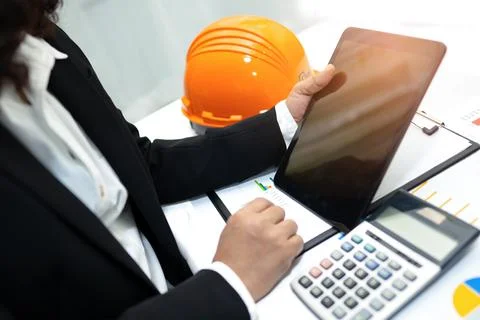 Architect or engineer working project accounting with graph and constructio.. Stockfoto's
