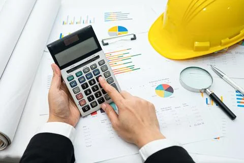 Architect or engineer working project accounting with graph with tools in o.. Stockfoto's