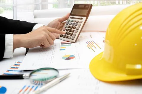 Architect or engineer working project accounting with graph and constructio.. Stockfoto's