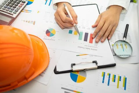 Architect or engineer working project accounting with graph with tools in o.. Stock Photos