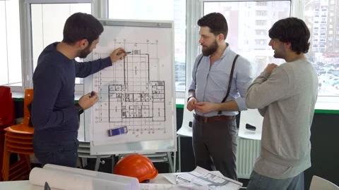 Architect passionately presenting building plans to engaged colleagues Stock Footage 311942348