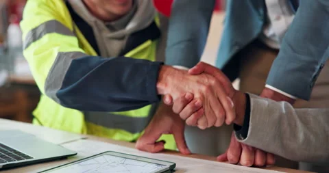 Architect, people and project with handshake for construction partnership or Stock Footage 338046490