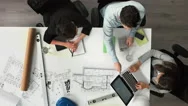 Architect Plans Arial View Business Meeting Showing Teamwork Stock Footage