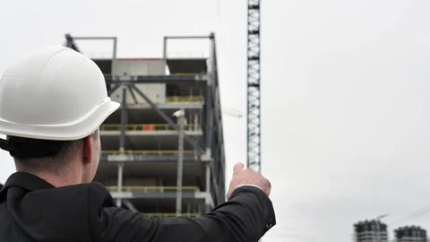 Architect pointing with hand at some details on construction, sites in Stock Footage 271591496