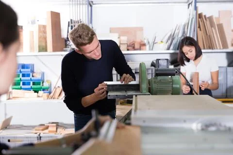 Architect polishing elements of model on sanding machine Stock Photos