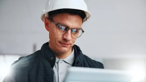 Architect, reading and man with tablet in building, online and plan for property Stock Photos