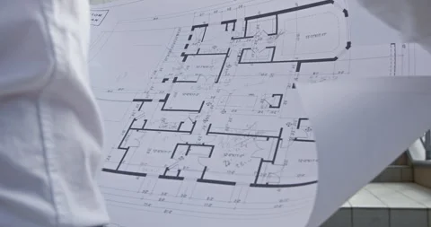 Architect reviews drawing with floor plan of project closeup Vidéo 259291211