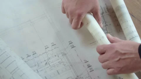 The architect rolls the construction plans on tracing paper into a neat 스톡 동영상 173453795