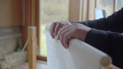 Architect rolls plans on tracing paper into a neat roll. Slow-motion. 60fps 스톡 동영상 173456322