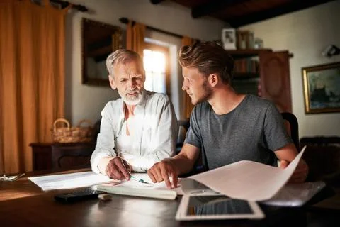 Architect, senior man and apprentice with documents discussion for learning Stock Photos